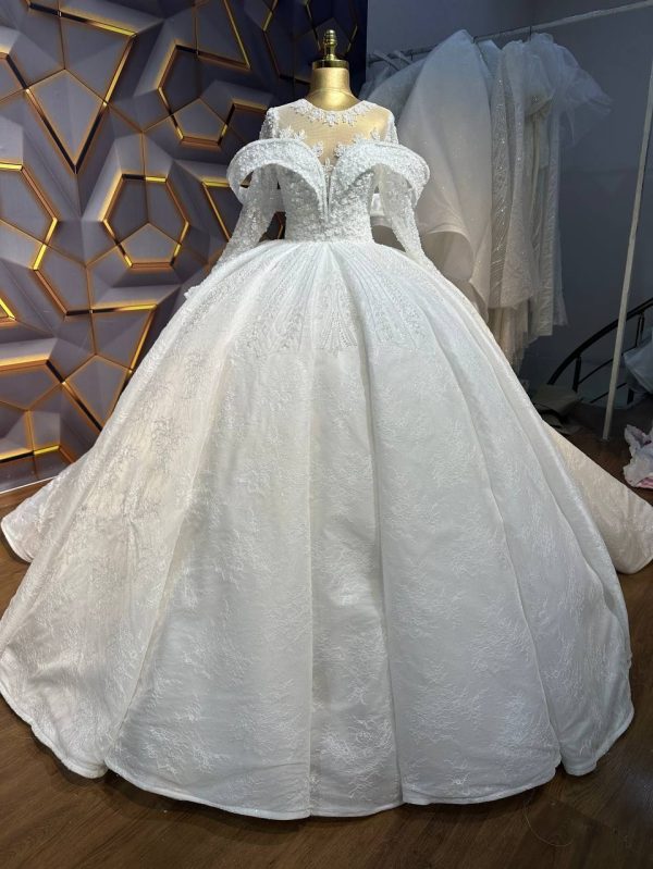 Off-shoulder ball gown wedding dress with intricate beaded bodice and a voluminous skirt.