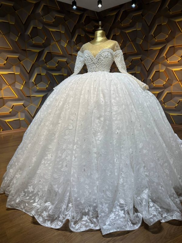 Long-sleeve lace ball gown wedding dress with sweetheart neckline and intricate detailing.
